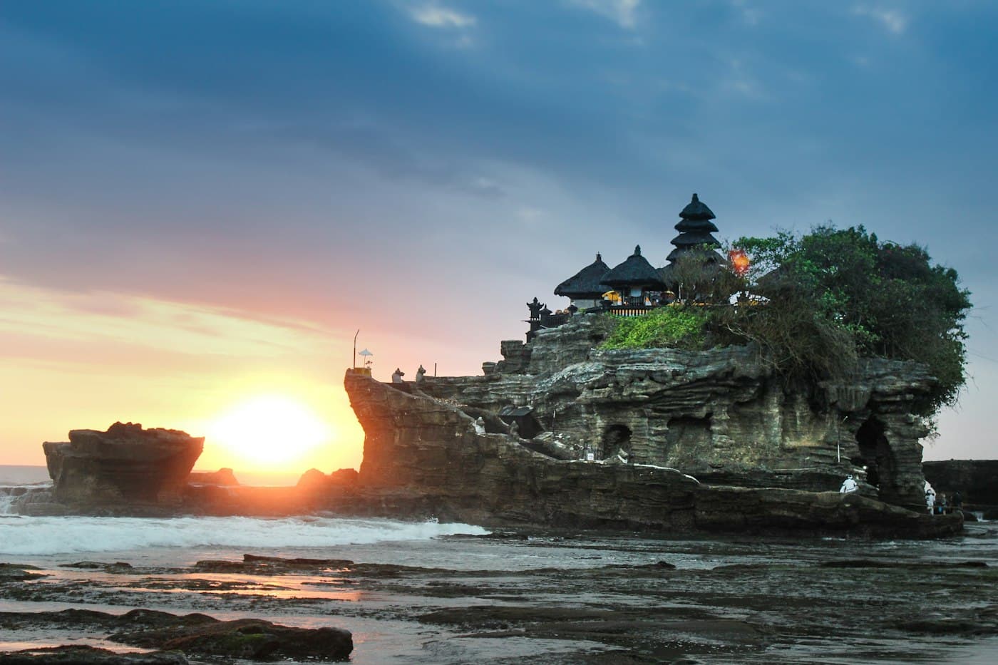 A sea temple on a rocky islet at sunset in Bali