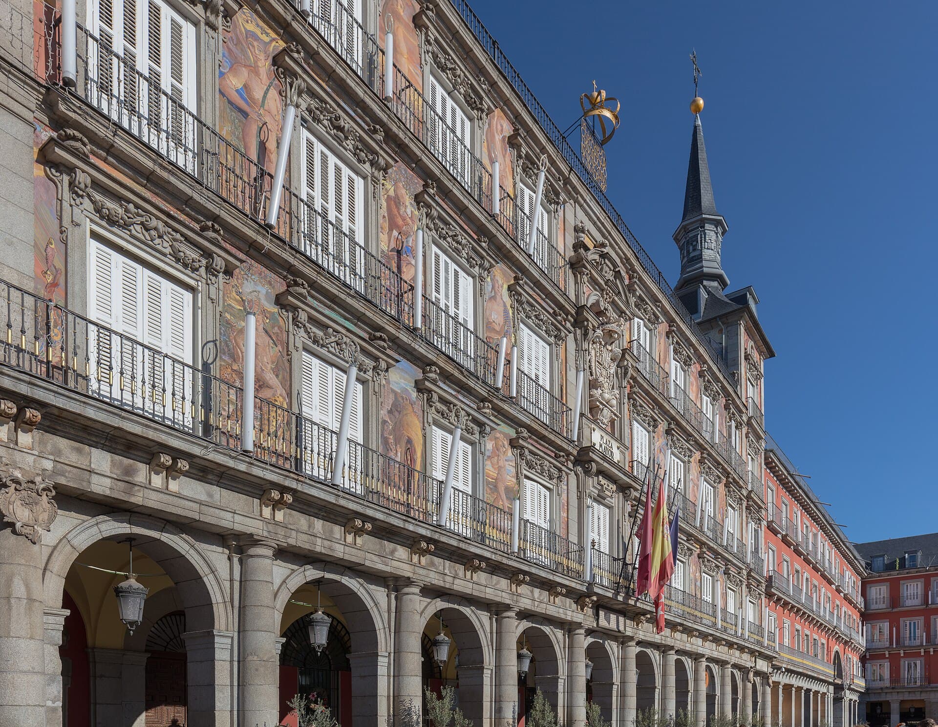The painted facade and stone arcades of Plaza Mayor in Madrid