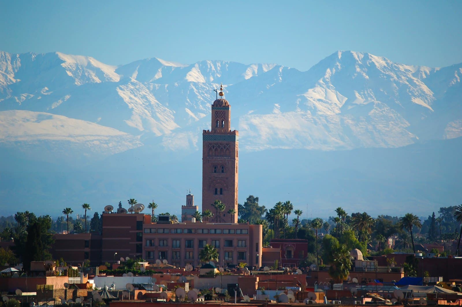 A minaret above Marrakech with the Atlas Mountains behind