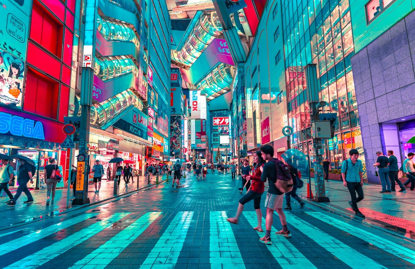 Pedestrians crossing a neon-lit street in Tokyo